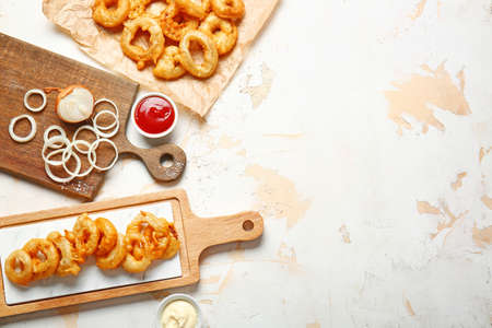 Composition with crispy fried onion rings on tableの写真素材