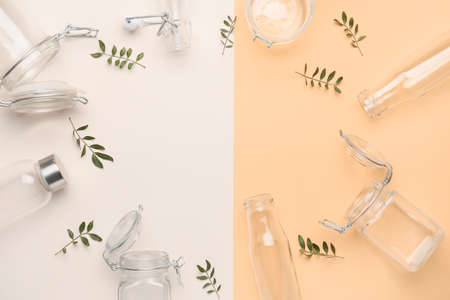 Frame made of glass eco bottles and jars on color backgroundの写真素材