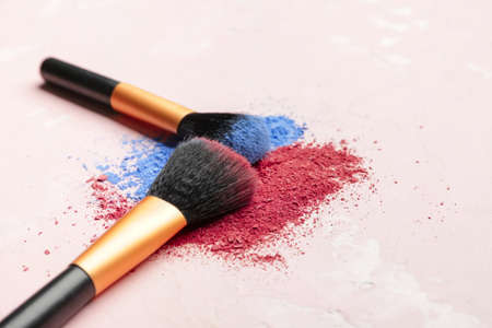 Makeup brushes and cosmetics on light backgroundの写真素材