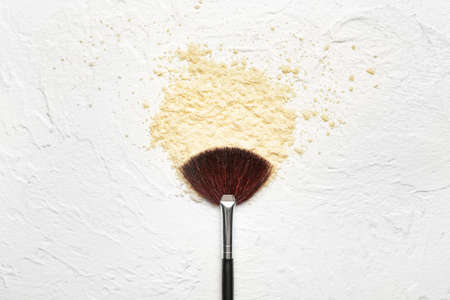 Makeup brush and cosmetics on light backgroundの写真素材