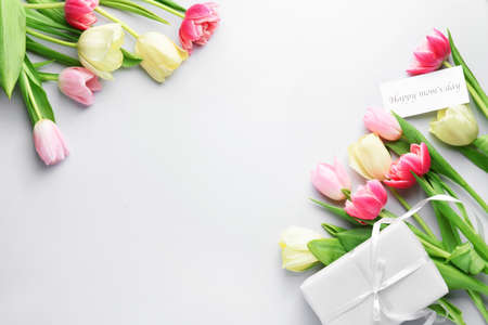 Beautiful flowers and gift for Mother's Day on white backgroundの写真素材