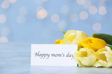 Beautiful flowers and card for Mother's Day on table
