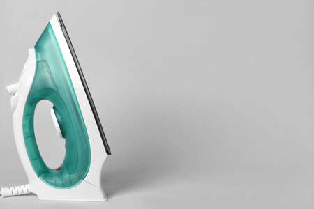 Electric iron on gray backgroundの写真素材