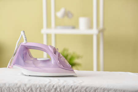 Electric iron on board at homeの写真素材