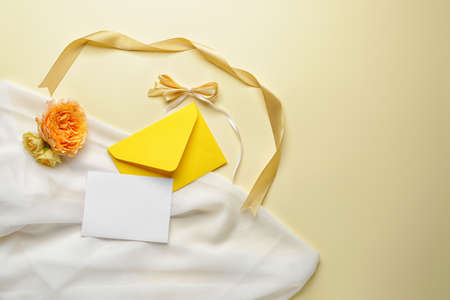Composition with empty greeting card and envelope on color backgroundの写真素材