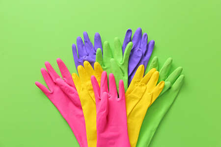 Set of rubber gloves on color backgroundの写真素材