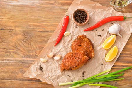 Tasty cooked pork steaks on tableの写真素材