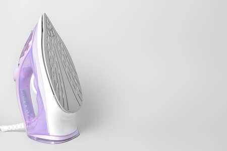 Electric iron on gray backgroundの写真素材