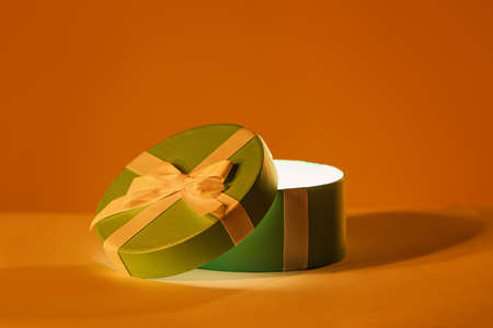 Beautiful open gift box on color backgroundの写真素材