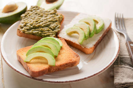 Tasty avocado sandwiches on plateの写真素材