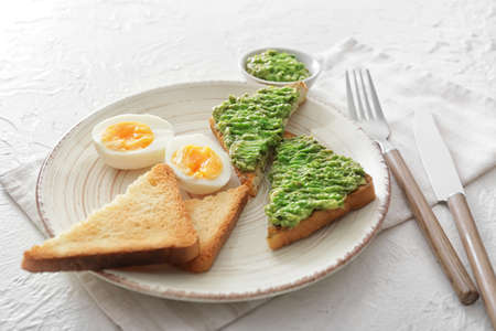 Plate with tasty avocado sandwiches on tableの写真素材