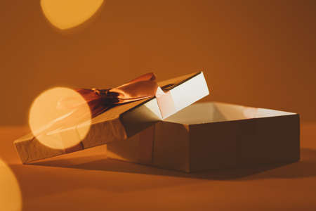 Beautiful open gift box on color backgroundの写真素材