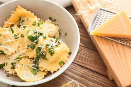 Plate with tasty ravioli on tableの写真素材