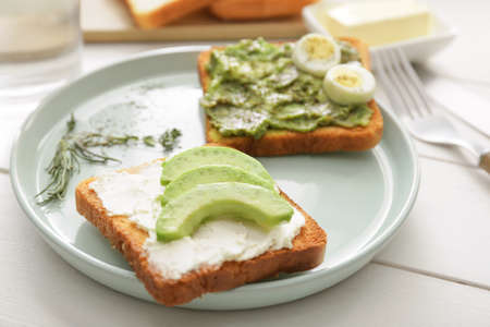 Tasty avocado sandwiches on plateの写真素材