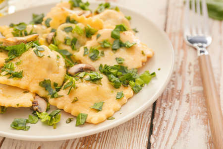 Plate with tasty ravioli on tableの写真素材