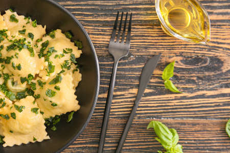 Plate with tasty ravioli on tableの写真素材