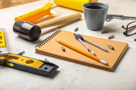 Builder's tools with notebook on white backgroundの写真素材