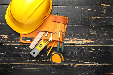 Builder's tools and hardhat on wooden backgroundの写真素材