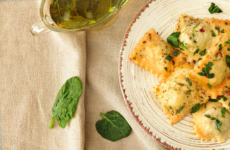 Plate with tasty ravioli on tableの写真素材