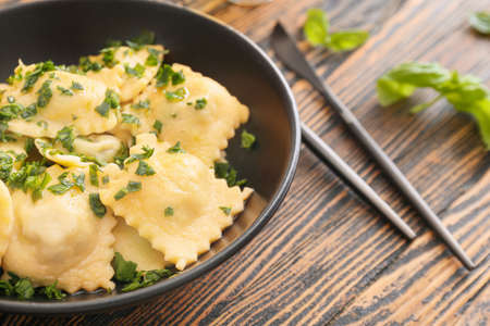 Plate with tasty ravioli on tableの写真素材