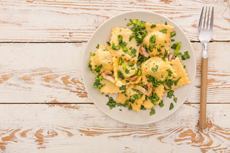 Plate with tasty ravioli on tableの写真素材