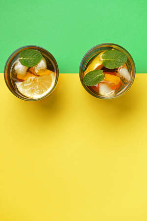Glasses of tasty cold ice tea on color backgroundの写真素材