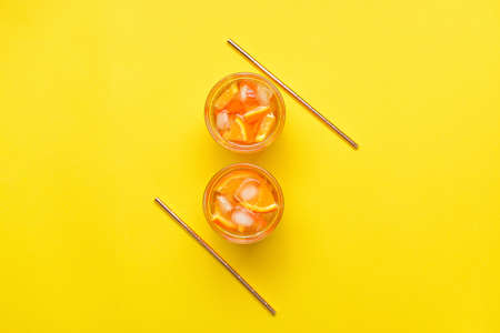 Glasses of tasty cold ice tea on color backgroundの写真素材