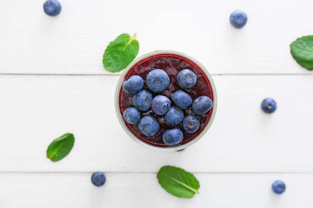 Glass with tasty panna cotta on white wooden backgroundの写真素材