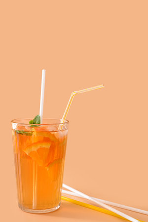 Glass of tasty cold ice tea on color backgroundの写真素材