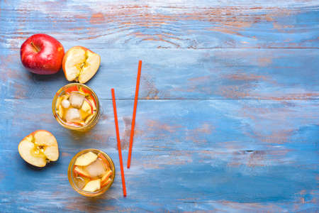 Glasses of tasty cold ice tea on color wooden backgroundの写真素材