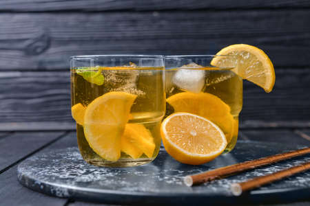 Glasses of tasty cold ice tea on dark wooden backgroundの写真素材