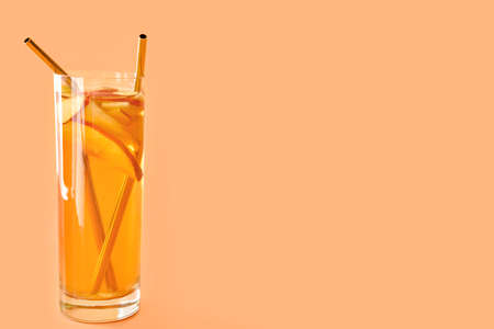 Glass of tasty cold ice tea on color backgroundの写真素材