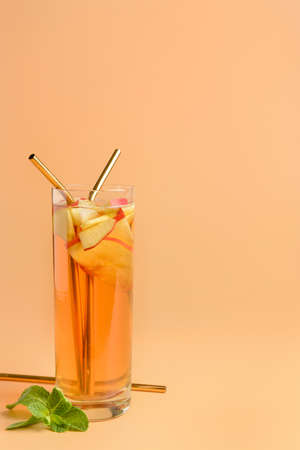 Glass of tasty cold ice tea on color backgroundの写真素材