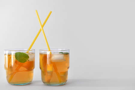 Glasses of tasty cold ice tea on gray backgroundの写真素材