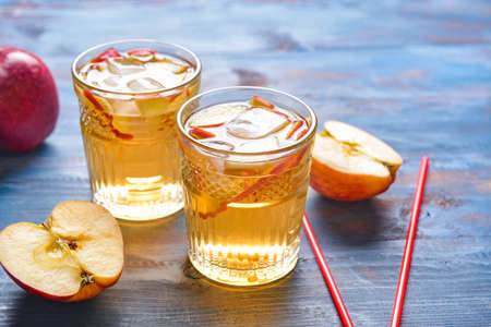 Glasses of tasty cold ice tea on color wooden backgroundの写真素材