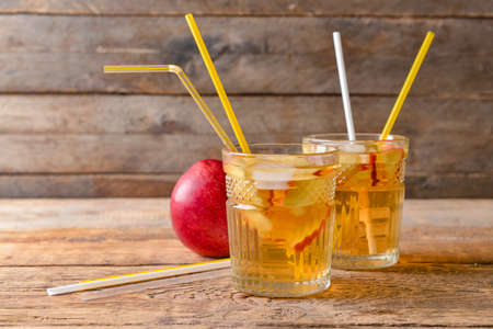 Glasses of tasty cold ice tea on wooden backgroundの写真素材