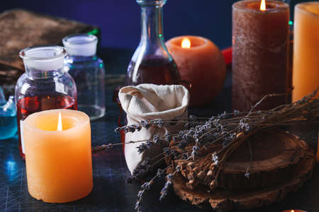Potions and candles on alchemist's tableの写真素材