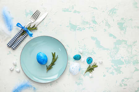 Beautiful Easter table setting on color backgroundの写真素材