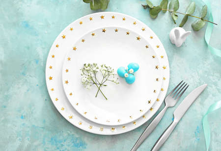 Beautiful Easter table setting on color backgroundの写真素材