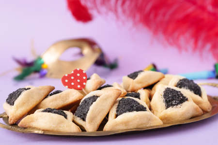 Tray with tasty hamantaschen for Purim holiday on color backgroundの写真素材