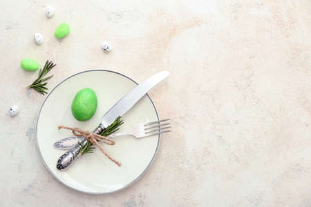 Beautiful Easter table setting on light backgroundの写真素材