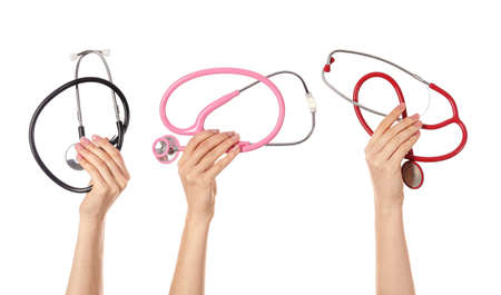 Hands with stethoscopes on white backgroundの写真素材