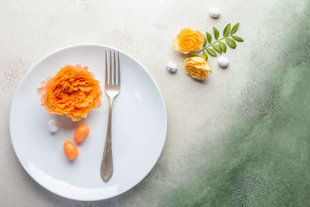 Beautiful Easter table setting on color backgroundの写真素材