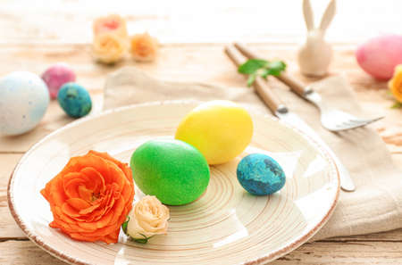 Beautiful Easter table setting on wooden background