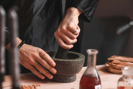 Male alchemist making elixir in laboratory, closeupの写真素材