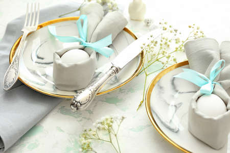 Beautiful Easter table setting on white background