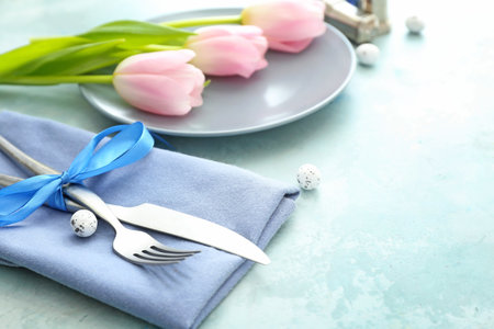 Beautiful Easter table setting on color background