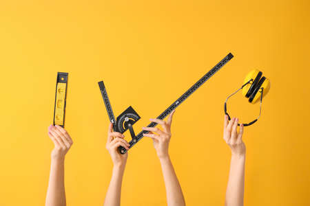 Many hands with architect's supplies on color backgroundの写真素材