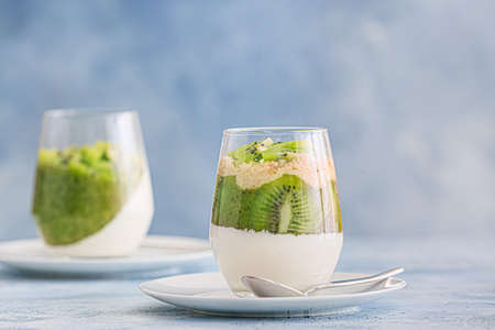 Glass with tasty panna cotta on color backgroundの写真素材
