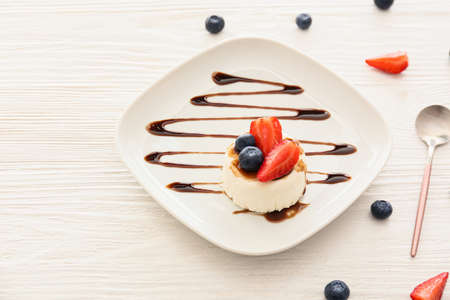 Plate with tasty panna cotta on tableの写真素材